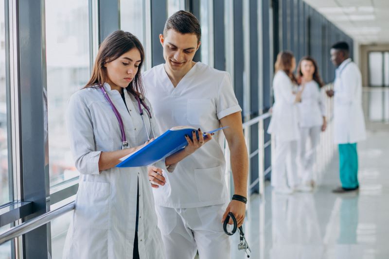 team-young-specialist-doctors-standing-corridor-hospital-min